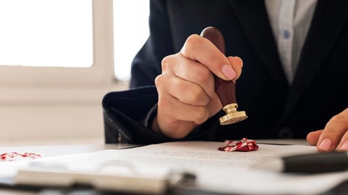 Person using wax seal certificate