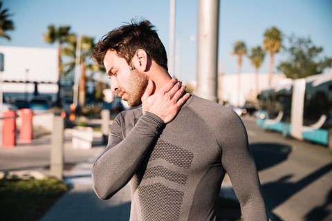 Man massaging aching neck