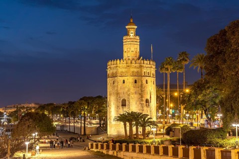 The historic Torre del Oro tower at dusk