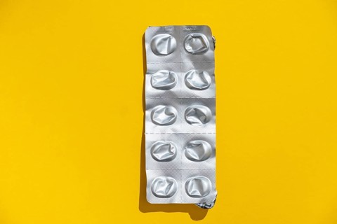 Empty tablet blister pack against a monochrome background