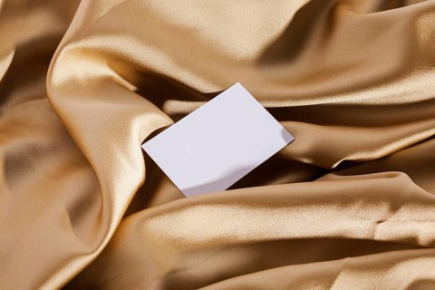 Top view white card golden cloth