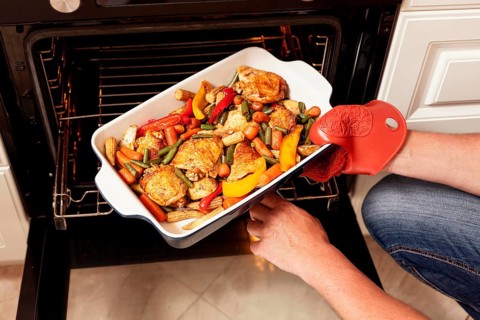 Tray food being put into oven cook