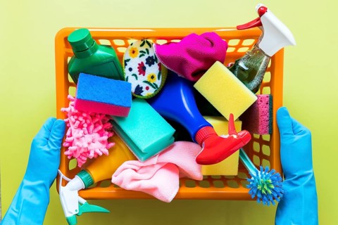 Close up person holding basket with cleaning products