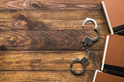 Flat lay frame with books handcuffs