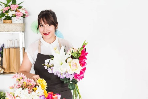 Portrait happy woman with bunch flowers