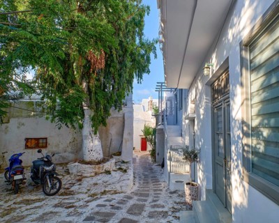 Charming traditional narrow streets and beautiful walkways of Greek island towns. Whitewashed houses