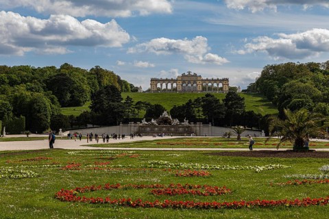 Schoenbrunn Palace Park with flower meadow Neptune Fountain and Gloriette