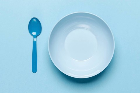 Top view empty blue bowl spoon