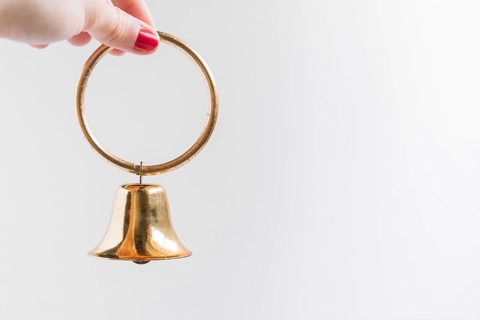 Woman holding small bell hand