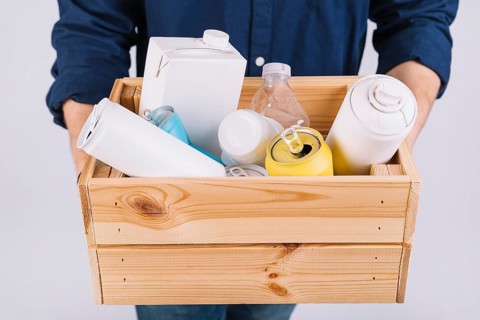Man s hand wooden box full bottles tin cans