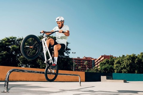 Teenage bmx rider performing tricks skatepark