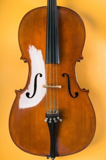 Wooden violin with string yellow background