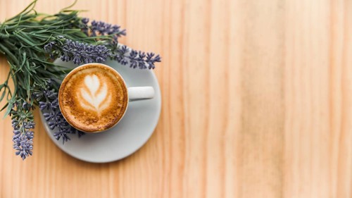 Coffee latte with lavender flower wooden surface