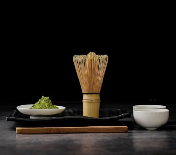 Front view matcha tea with bamboo whisk