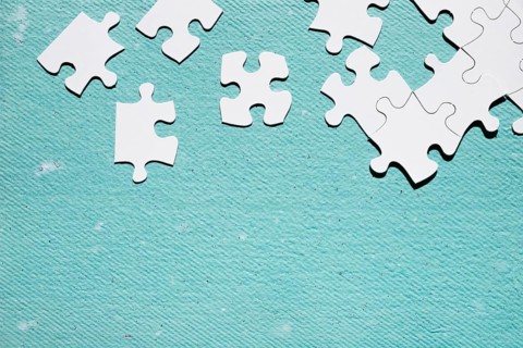 White jigsaw puzzle piece blue textured surface