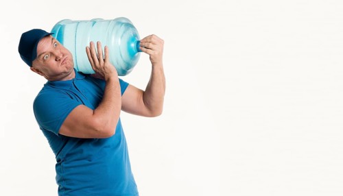 Delivery man carrying heavy water bottle
