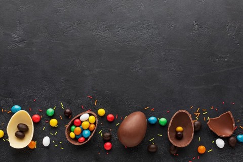 Top view chocolate easter eggs filled with colorful candy