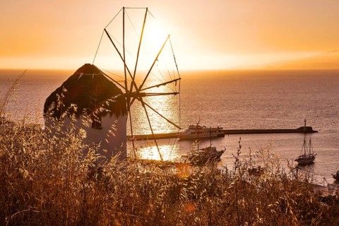 Golden sunset over sea horizon in Mykonos