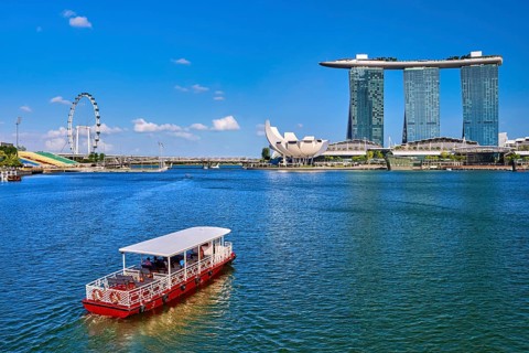 Tourist cruise boat approaching Marina Bay Sands