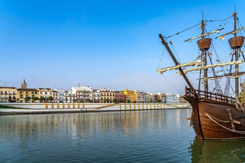 Replica of the Nao Victoria 500 and the colourful houses of the Triana district on the Guadalquivir River