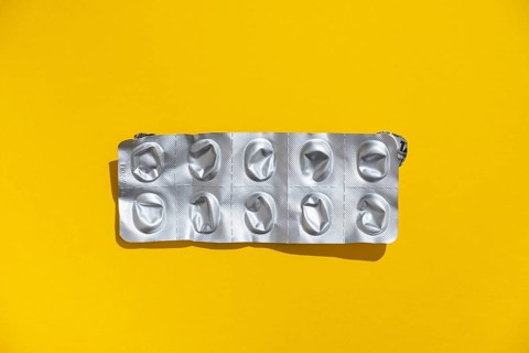 Empty tablet blister pack against a monochrome background