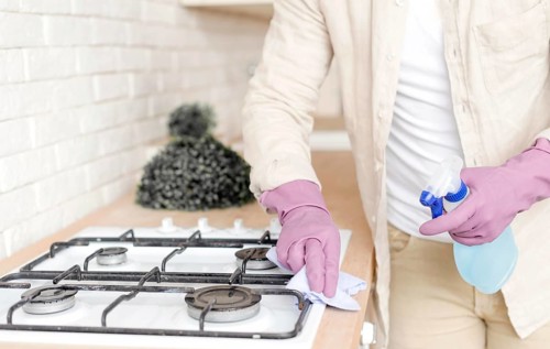 Man disinfecting stove