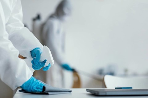 People disinfecting biohazard area