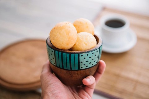 Person holding cheese balls bowl