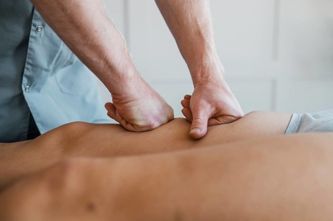 Male physiotherapist massage session with female patient