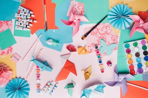 Top view origami craft paint tube paintbrush straw colored paper