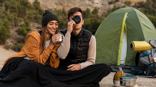 Couple camping drinking tea together