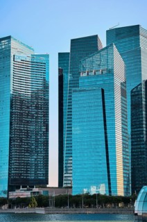 Group of buildings in CBD or Central Business District buildings over Marina Bay waters in day light