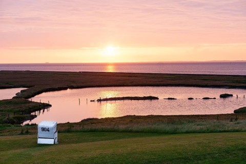 A beach chair on the meadow at sunset on Hallig Langeness
