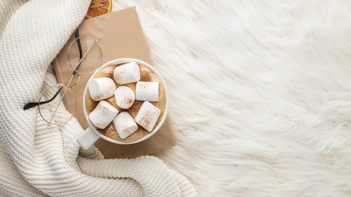 Top view cup hot marshmallows glasses book