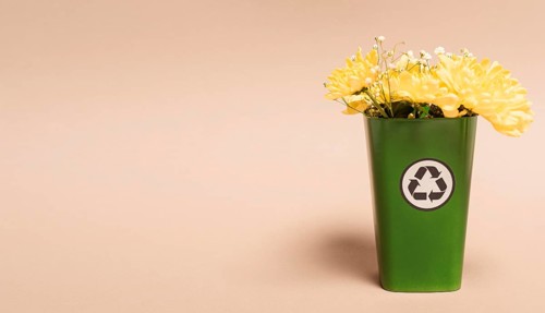 Copy space recycle bin with flowers
