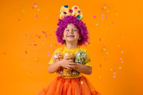 Girl with clown costume candy