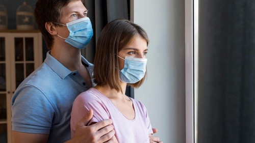Man woman wearing face mask home