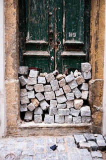 A pile of stones in front of a house door in Lisbon