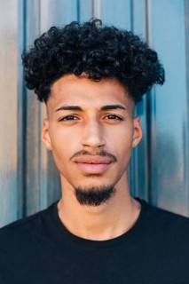 Confident ethnic man with curly hair