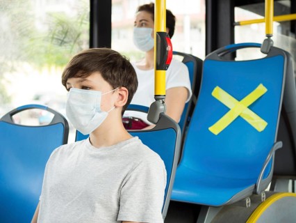 People keeping social distance bus