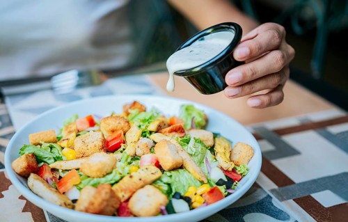 Close up of hand preparing a vegetable salad. Concept of healthy food and lifestyle