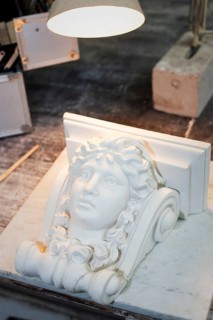 Female head in stucco on a workbench