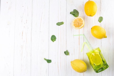 Lemons bright colored glass with straw