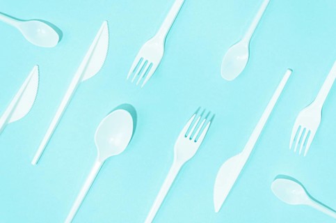 White disposable cutlery composition turquoise background