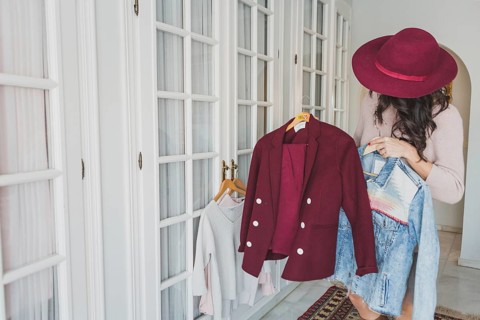 Stylish young woman looking burgundy suit