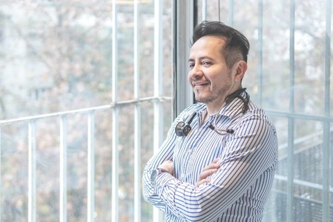 Portrait of latin doctor posing in his office