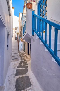 Charming traditional narrow streets and beautiful alleyways of Greek island towns. Whitewashed houses
