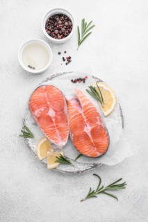 Slices fresh salmon slices white plate