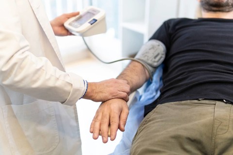 Doctor taking patient's blood pressure