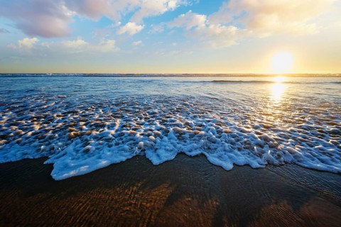 Atlantic ocean sunset with surging waves at Fonte da Telha beach